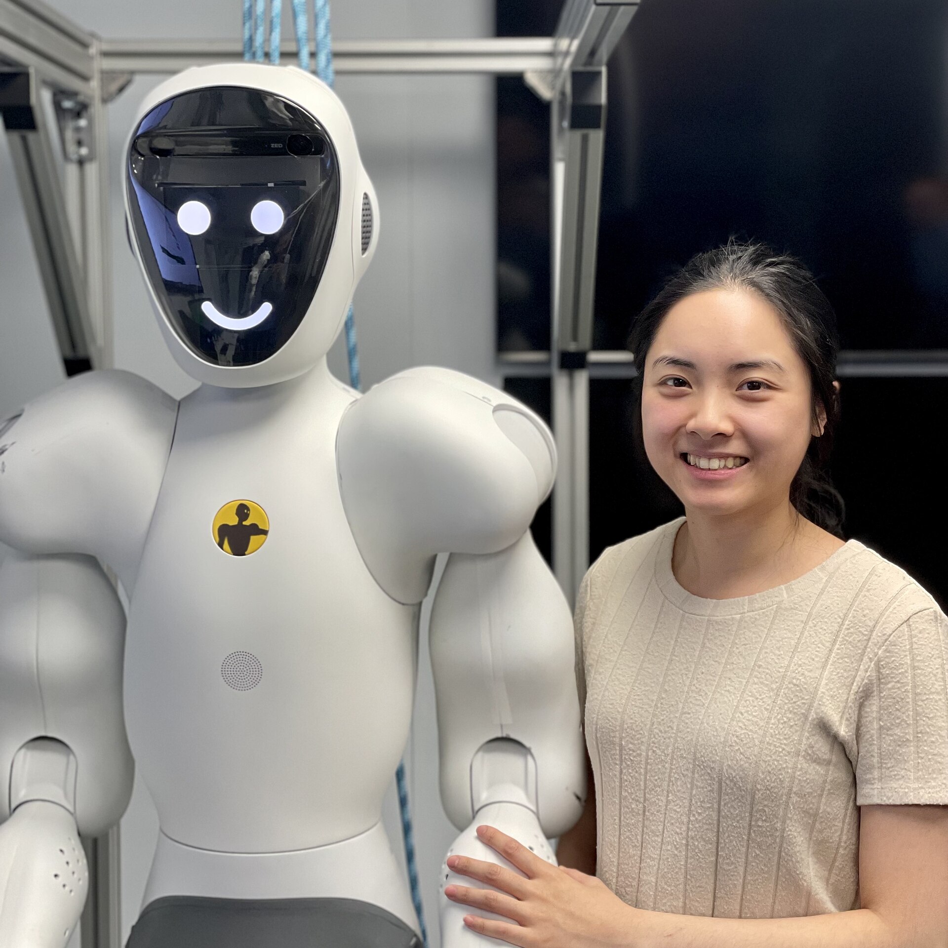 A person working alongside a humanoid collaborative robot